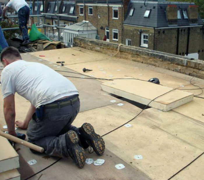 Insulation-laid-over-flat-roof-rafters