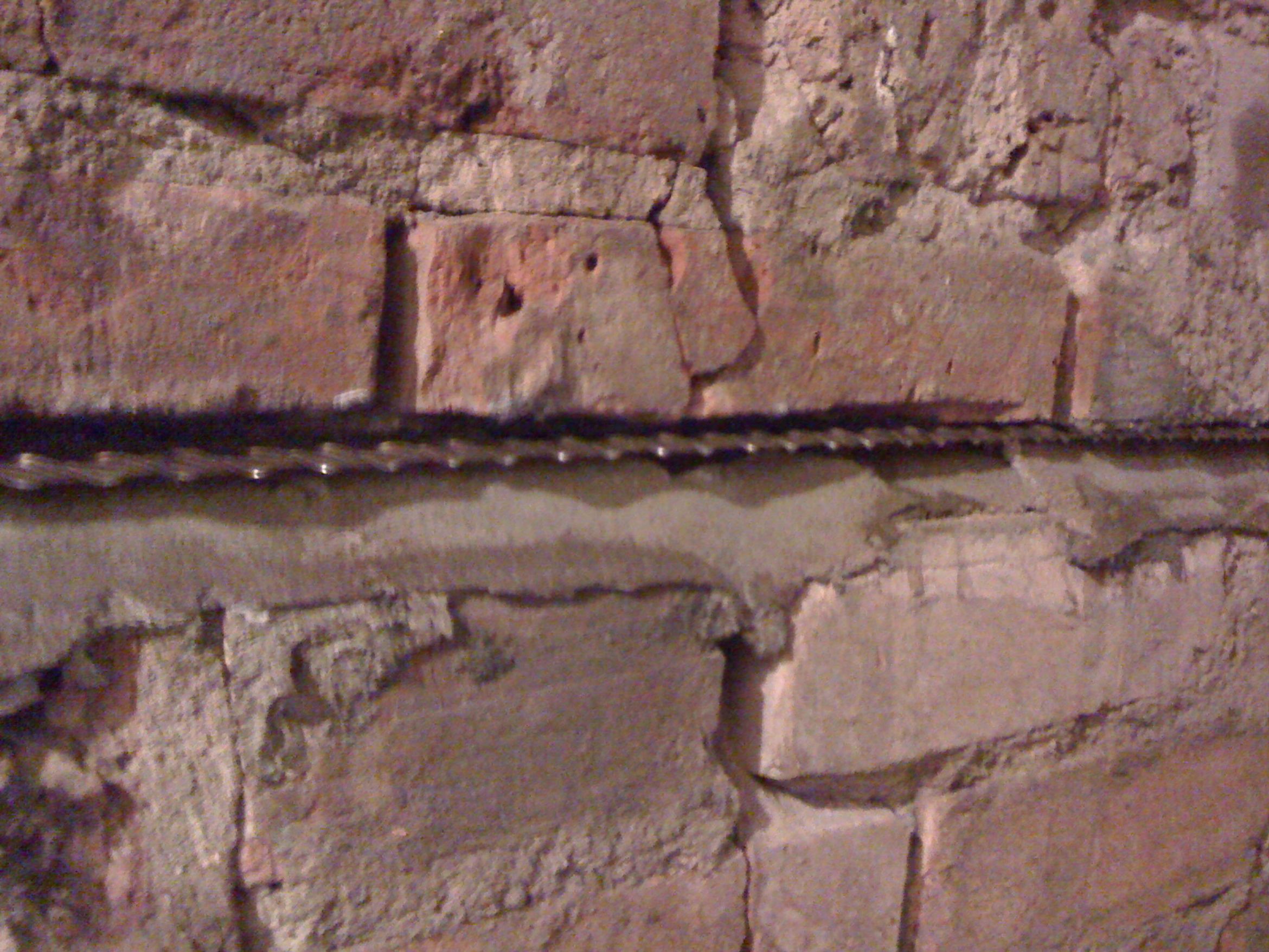 installing a series of masonry crack stitching bars